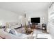 Bright living room features hardwood floors, a plush sofa, a flat screen TV and natural light at 284 Shadybrook Dr, Summerville, SC 29486