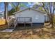 Backyard view of the house with a wooden deck and stairs at 2925 Alabama Dr, North Charleston, SC 29405