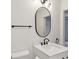 Bathroom with modern white vanity, black hardware and towel bar, with oval mirror at 2925 Alabama Dr, North Charleston, SC 29405