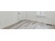 Light-filled bedroom with wood-look vinyl flooring and a window with shutters at 2925 Alabama Dr, North Charleston, SC 29405