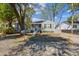 Charming one-story home with a small porch, grey siding and a gravel yard at 2925 Alabama Dr, North Charleston, SC 29405