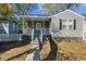 Charming grey home with a cozy front porch, black shutters, and green landscaping at 2925 Alabama Dr, North Charleston, SC 29405
