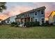 Back exterior showcasing a well-maintained yard, screened porch and string lights at 306 Long Pier St, Summerville, SC 29486