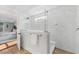 Bright bathroom with a frameless shower, marble walls and floors, and modern fixtures at 306 Long Pier St, Summerville, SC 29486