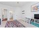 Light-filled bedroom features neutral decor, a colorful rug, a view to the bathroom, and ample storage at 306 Long Pier St, Summerville, SC 29486