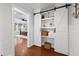 Bedroom hallway leading to a Primary bedroom with a sliding barn door closet with shelves at 306 Long Pier St, Summerville, SC 29486