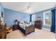 Bright blue bedroom with natural light, ceiling fan, and wood furnishings at 306 Long Pier St, Summerville, SC 29486