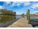 Scenic view from a wooden dock extending into a peaceful lake, with trees and houses in the background at 306 Long Pier St, Summerville, SC 29486
