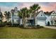 Two-story home featuring palm trees, landscaped lawn, and a two-car garage in a lovely neighborhood at 306 Long Pier St, Summerville, SC 29486