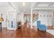 Spacious foyer featuring hardwood floors, decorative columns, and a staircase leading to the upper level at 306 Long Pier St, Summerville, SC 29486