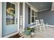 Welcoming front porch features rocking chairs, a wreath on the front door, and charming decor at 306 Long Pier St, Summerville, SC 29486