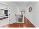 Bright hallway with hardwood floors, white walls, and a staircase leading to the upper level at 306 Long Pier St, Summerville, SC 29486