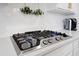 Stainless steel Frigidaire gas cooktop with four burners set against white countertops and backsplash at 306 Long Pier St, Summerville, SC 29486