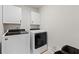 Functional laundry room with white washer and dryer, and storage cabinets at 306 Long Pier St, Summerville, SC 29486