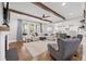 Spacious living room with hardwood floors, wood beams, and a smooth transition to the open kitchen at 306 Long Pier St, Summerville, SC 29486