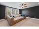 Relaxing living area featuring a plush sofa, large windows, and contemporary ceiling fan at 306 Long Pier St, Summerville, SC 29486