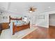 Bright main bedroom with wood floors, ceiling fan, and a large, comfortable-looking bed at 306 Long Pier St, Summerville, SC 29486