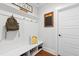 Inviting mudroom with seating, shoe storage, hooks for coats, and modern decor at 306 Long Pier St, Summerville, SC 29486