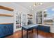 Home office with French doors, wood floors, a custom cabinet, and a window with a view to the outside at 306 Long Pier St, Summerville, SC 29486