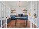 Well-lit office with custom built-ins, hardwood floors, and French doors, ideal for remote work at 306 Long Pier St, Summerville, SC 29486