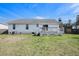 The backyard features a well-maintained lawn, a deck, and a clear view of the house's exterior at 3075 Old Highway 52, Moncks Corner, SC 29461