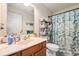 Well-lit bathroom featuring a vanity, mirror, and coordinated decor with botanical shower curtain at 3075 Old Highway 52, Moncks Corner, SC 29461