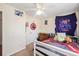 This bedroom features neutral walls, ceiling fan, and a cozy bed with playful and gamer-themed decor at 3075 Old Highway 52, Moncks Corner, SC 29461