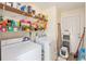 Convenient laundry room with a washer, dryer, and plenty of storage shelving at 3075 Old Highway 52, Moncks Corner, SC 29461