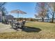 Inviting backyard patio with an umbrella-covered table, leading to a lush lawn and waterfront at 318 Archibald Dr, Goose Creek, SC 29445