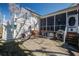 An outdoor seating area with a screened-in porch and stairway to a deck, providing a great place to unwind at 318 Archibald Dr, Goose Creek, SC 29445