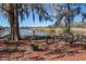 Picturesque lakeside view with a bench, mature trees, and serene water at 318 Archibald Dr, Goose Creek, SC 29445