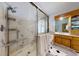 Spacious bathroom featuring marble-tiled shower, glass door, double sink vanity, and storage cabinets at 318 Archibald Dr, Goose Creek, SC 29445