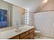 Well-lit bathroom featuring vanity with lights, patterned wallpaper, and shower/tub combo at 318 Archibald Dr, Goose Creek, SC 29445