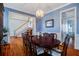 Open dining area featuring a chandelier, wainscotting, and hardwood floors adjacent to the staircase at 318 Archibald Dr, Goose Creek, SC 29445