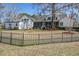 Charming white home featuring a spacious lawn, a screened porch, and a classic black fence at 318 Archibald Dr, Goose Creek, SC 29445