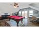 Bright game room features a pool table, TV, and access to an outdoor balcony with a water view at 318 Archibald Dr, Goose Creek, SC 29445