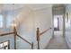 Hallway with natural light and a decorative light fixture over the wooden railing staircase at 318 Archibald Dr, Goose Creek, SC 29445