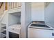 Bright laundry room featuring modern washer and dryer and shelves at 318 Archibald Dr, Goose Creek, SC 29445