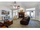 Comfortable living room with fireplace, ceiling fan, hardwood floors, and access to an outdoor patio at 318 Archibald Dr, Goose Creek, SC 29445