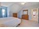 Well-lit main bedroom with light-blue walls featuring ample dresser storage and an adjacent doorway at 318 Archibald Dr, Goose Creek, SC 29445