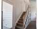 Carpeted staircase with white railing and wood banister leading to the upper level at 318 Archibald Dr, Goose Creek, SC 29445
