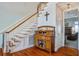 Classic staircase with hardwood steps and white risers complemented by a display cabinet at 318 Archibald Dr, Goose Creek, SC 29445