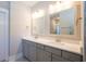 Bright bathroom featuring double sinks with modern lighting and a door leading to another area at 332 Dahlia Row Dr, Summerville, SC 29486