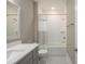 Bright bathroom featuring a tiled shower-tub combination and modern vanity with framed mirror at 332 Dahlia Row Dr, Summerville, SC 29486