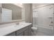Bright bathroom featuring a tiled shower-tub combination and modern vanity with framed mirror at 332 Dahlia Row Dr, Summerville, SC 29486