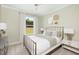 Comfortable bedroom with a metal frame bed, soft linens, and a calming color palette at 332 Dahlia Row Dr, Summerville, SC 29486