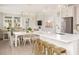 Bright, open kitchen with a white island, pendant lighting, and stainless steel appliances at 332 Dahlia Row Dr, Summerville, SC 29486
