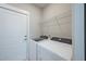 Well-lit laundry room with modern appliances and a door leading to another area at 332 Dahlia Row Dr, Summerville, SC 29486