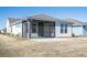 Cozy screened porch with concrete patio in a well-maintained backyard, perfect for outdoor relaxation at 332 Dahlia Row Dr, Summerville, SC 29486