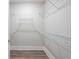 Walk-in closet featuring laminate floors, baseboards, and wire shelving throughout the space at 332 Dahlia Row Dr, Summerville, SC 29486